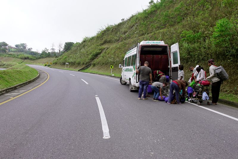 Venezuelan migrants load their belongings on a public service bus
