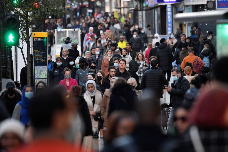Shoppers walk after new nationwide restrictions were announced