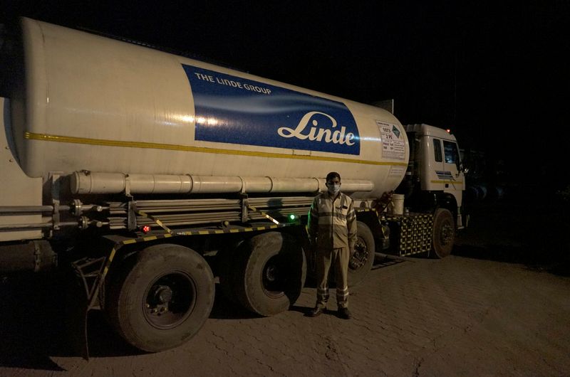 Subhas Kumar Yadav poses in front of a tanker carrying