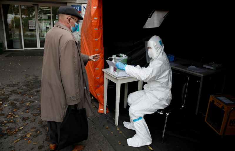 FILE PHOTO: A health worker in protective suit gives a