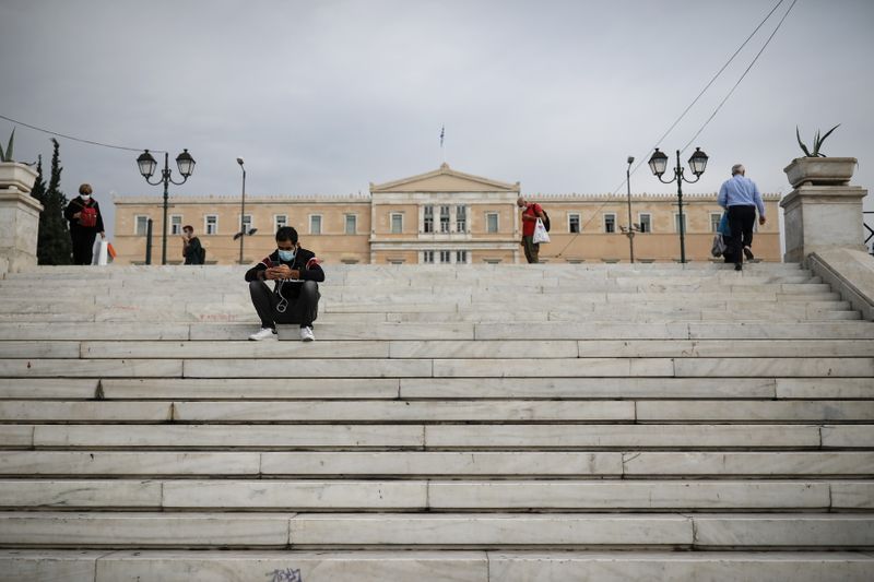 People wearing protective face masks are seen on Syntagma square,
