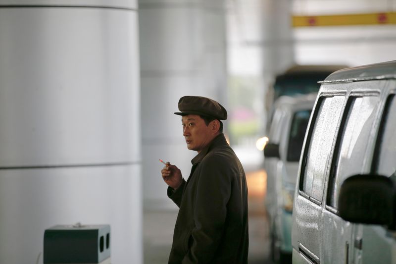 FILE PHOTO: A man smokes a cigarette outside the airport