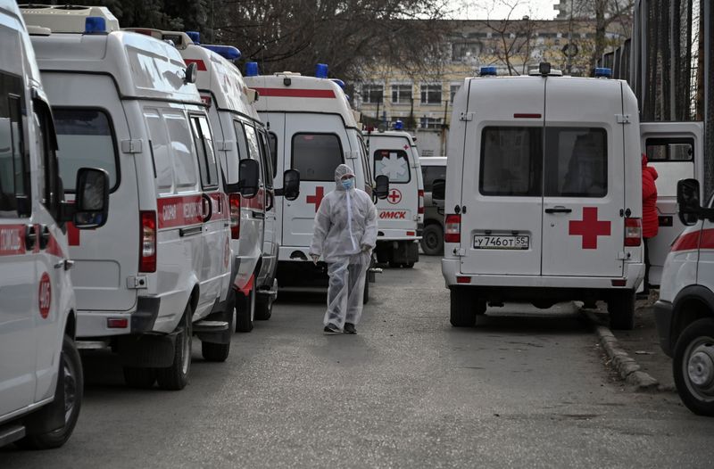 Ambulances are parked outside a hospital amid the outbreak of