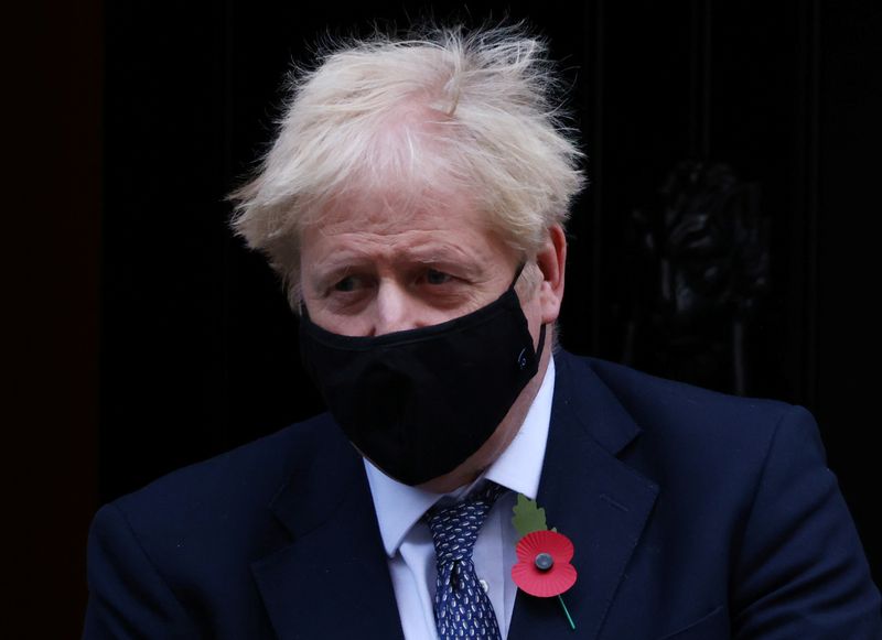 Britain’s Prime Minister Boris Johnson wearing a face mask as