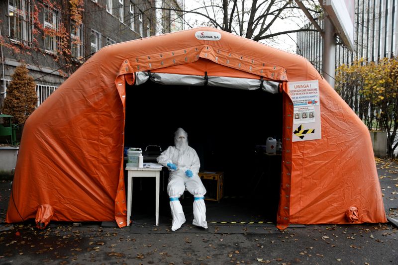 FILE PHOTO: A health worker in protective suit waits for