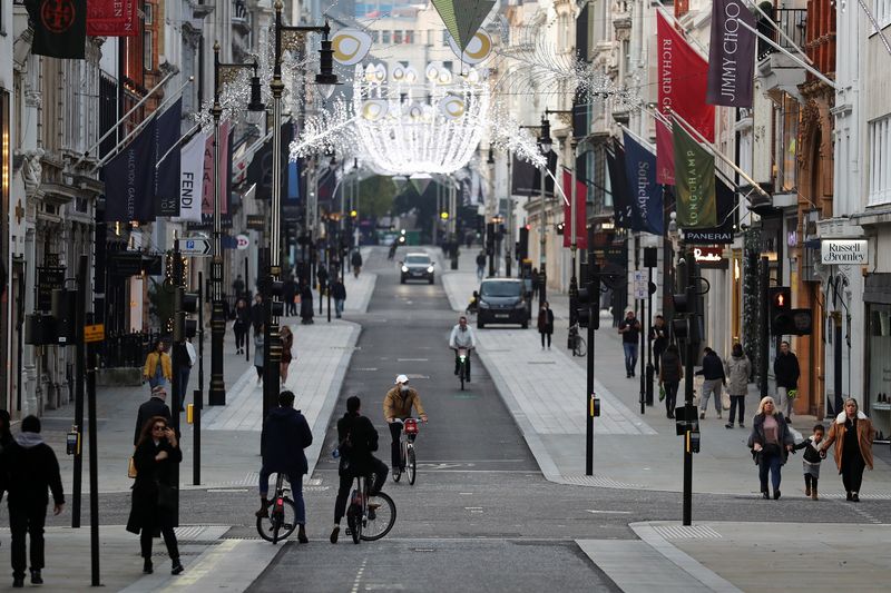 FILE PHOTO: Pedestrians and cyclists move through New Bond Street