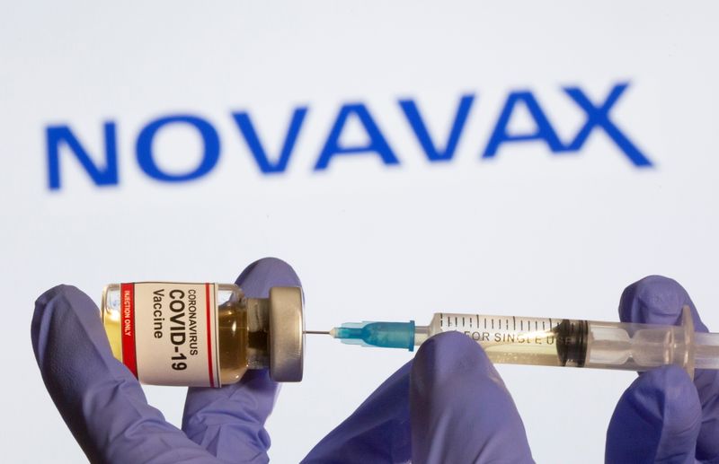 A woman holds a small bottle labeled with a “Coronavirus
