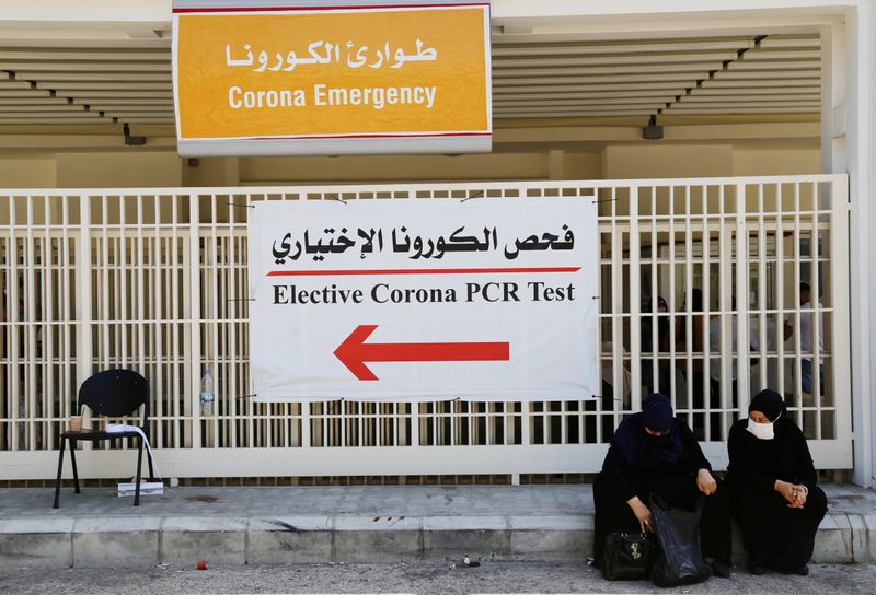 FILE PHOTO: Women wait to get tested for the coronavirus