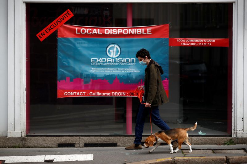 A man walks his dog past a commercial space for