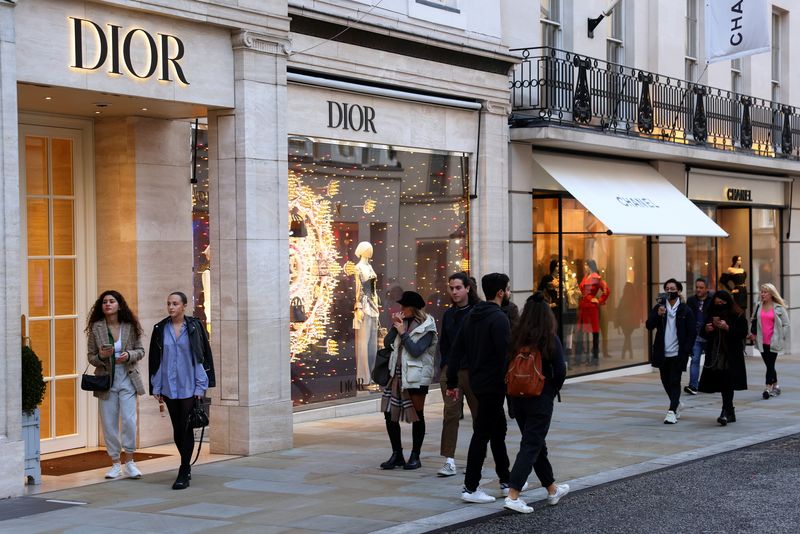 FILE PHOTO: Pedestrians walk past a Dior store on New