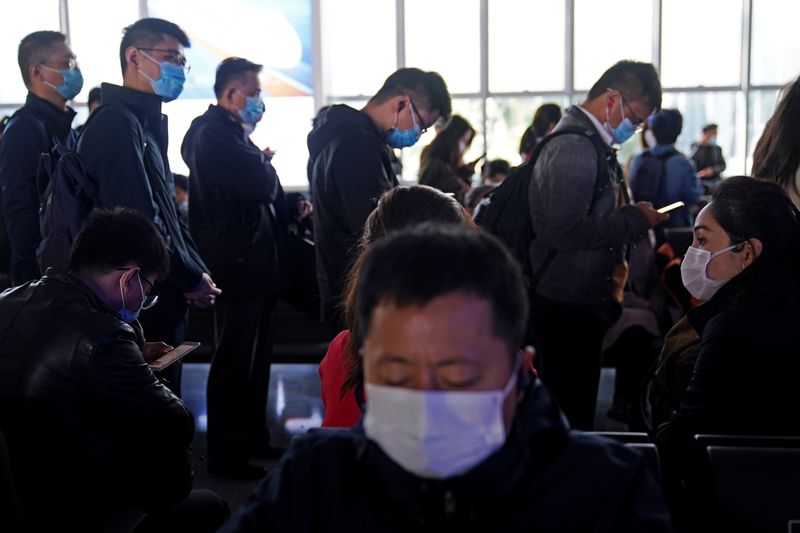 People wear face masks amid the global outbreak of the