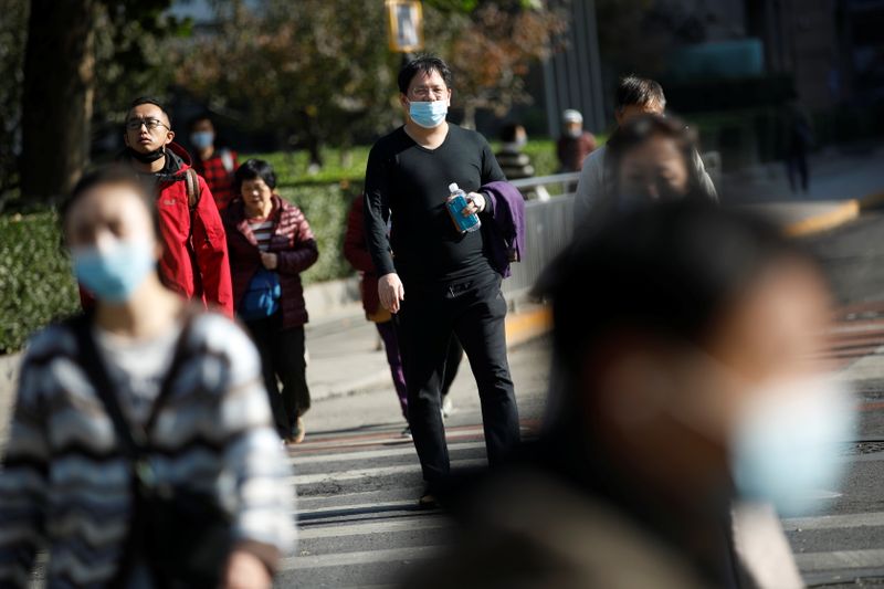 People wearing masks following the coronavirus disease (COVID-19) outbreak walk