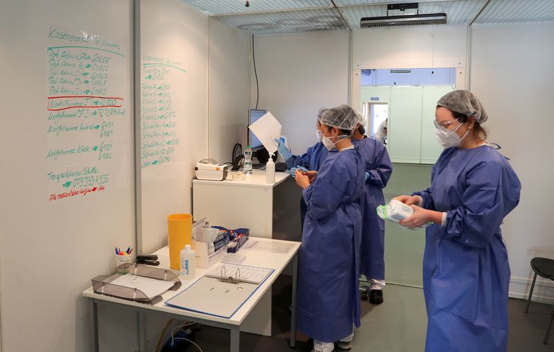 Employees are seen at a newly-opened COVID-19 testing site in