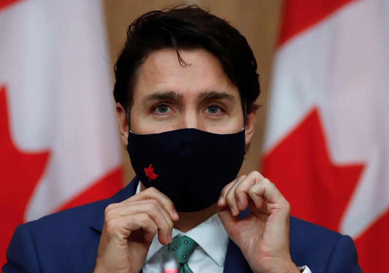 Canadian Prime Minister Justin Trudeau puts on a mask at