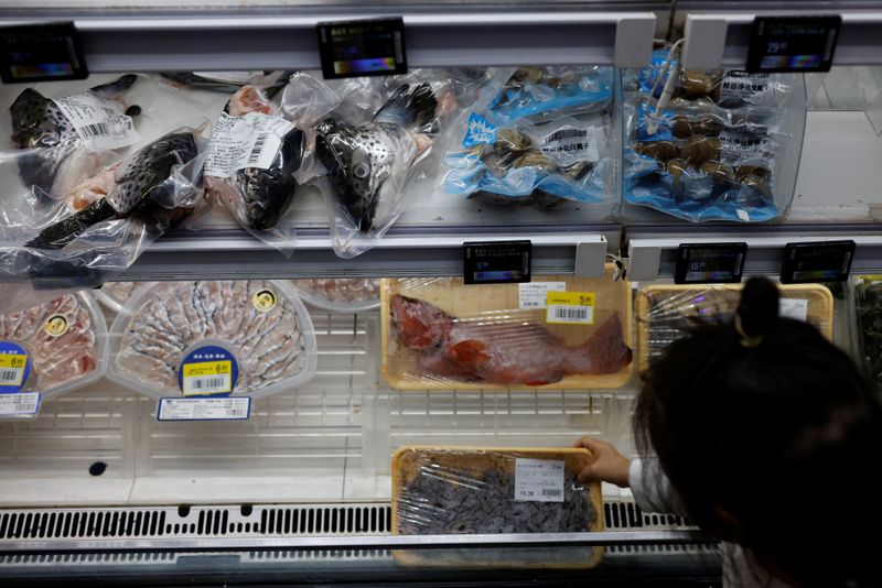 A customer shops for seafood at a supermarket in Shanghai