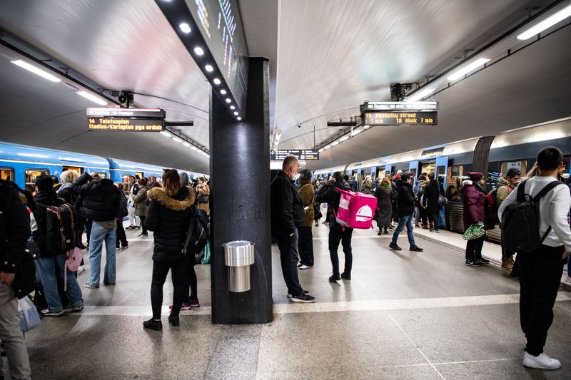 Commuters at Stockholm Central metro station catch trains during rush