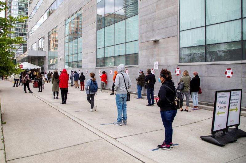 FILE PHOTO: People wait in line at a coronavirus disease