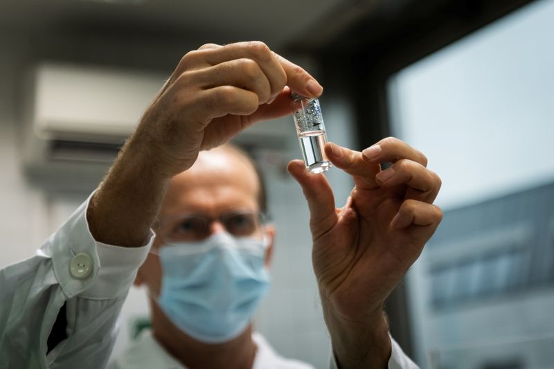 Laboratory assistant holds a tube with Russia’s “Sputnik-V” vaccine against