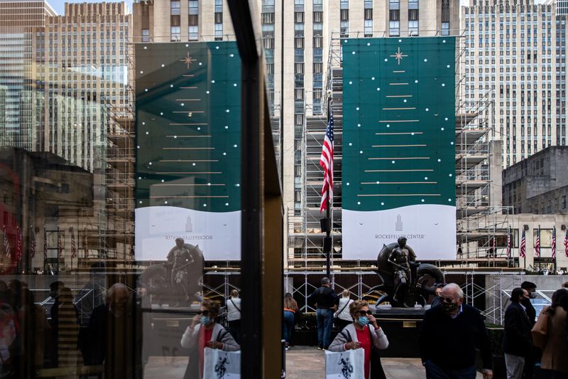 People wearing protective masks are seen at Rockefeller Center as