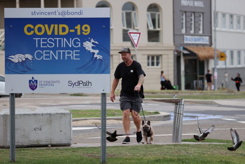 A man walks his dog near a COVID-19 testing centre