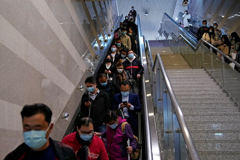 People wear face masks at Hongqiao Railway Station amid the