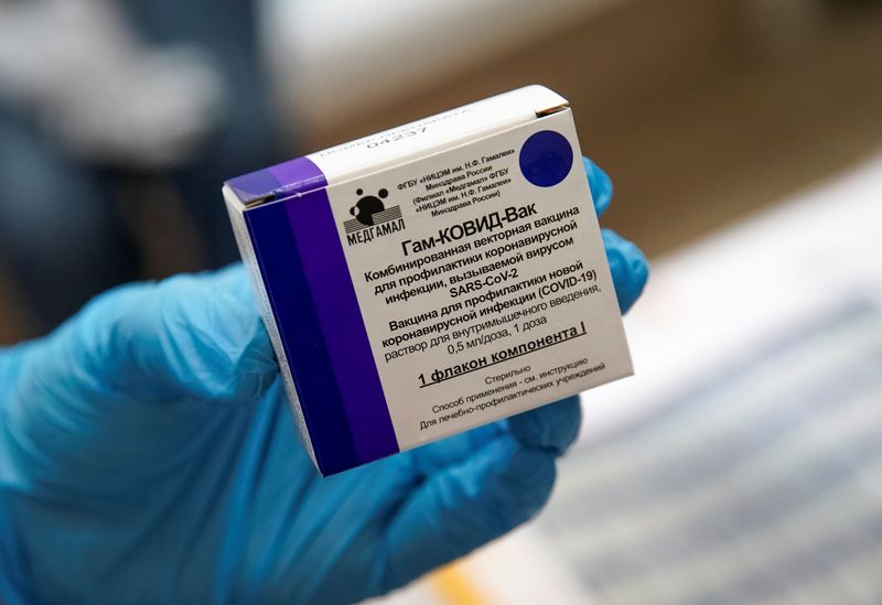 A nurse shows a box with Russia’s “Sputnik-V” vaccine against