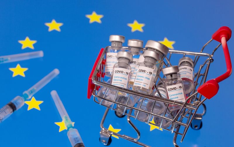 A small shopping basket filled with vials labeled  “COVID-19