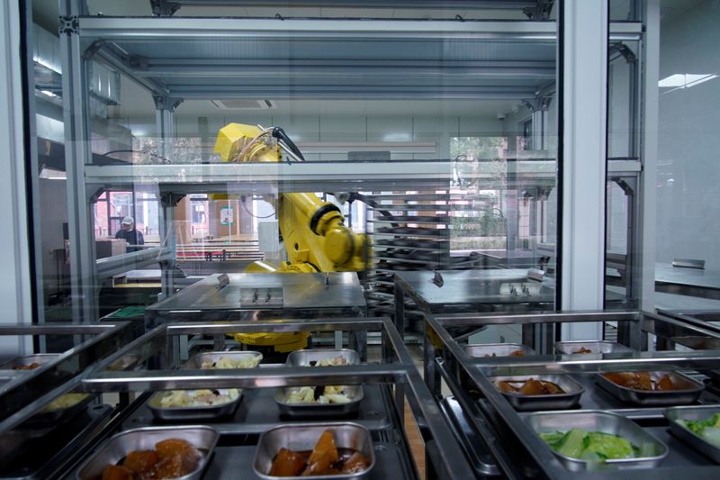 A robot chef makes food for lunch at Minhang Experimental