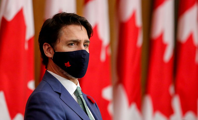 FILE PHOTO: Canadian Prime Minister Justin Trudeau listens while wearing