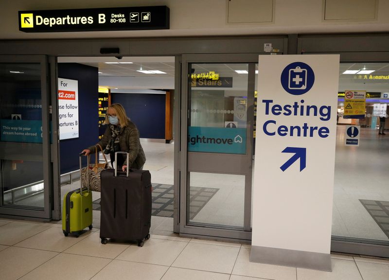 FILE PHOTO:  A passenger walks past a testing centre