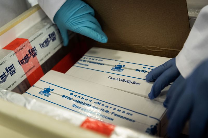 Laboratory assistants unpack Russia’s “Sputnik-V” vaccine against the coronavirus disease