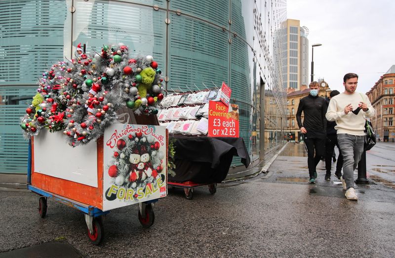 People walk past a wreath stall in Manchester