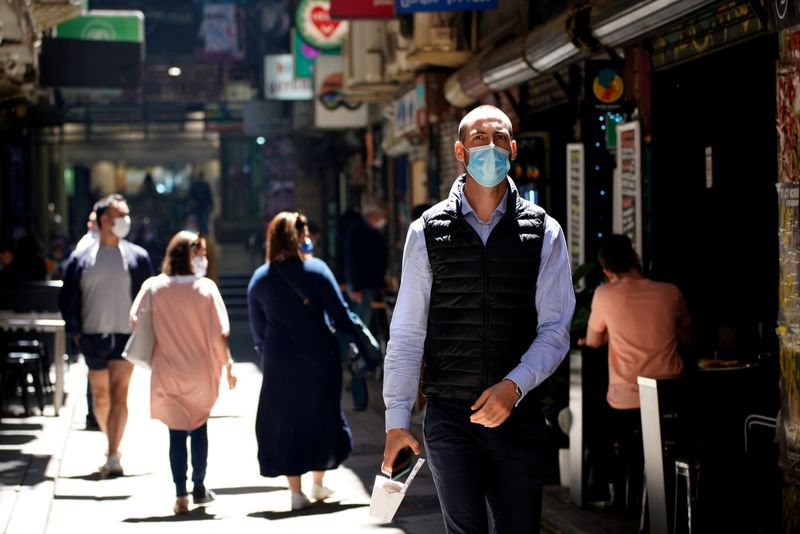 People walk down a city laneway after coronavirus disease restrictions