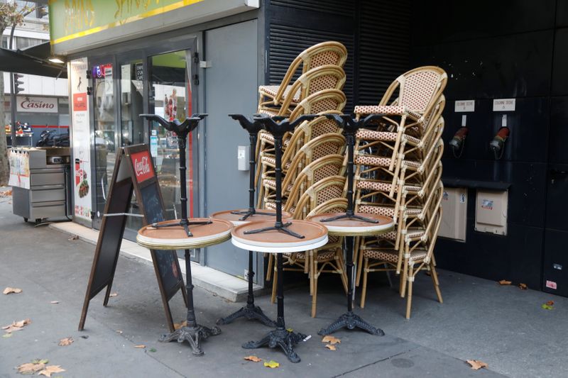 Chairs are stacked outside a closed restaurant in Paris