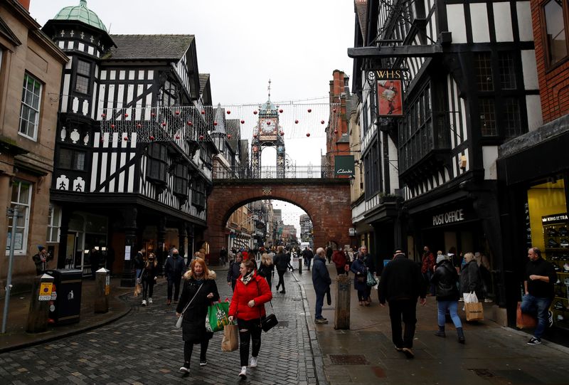 Shoppers walk through the city centre in Chester, Britain
