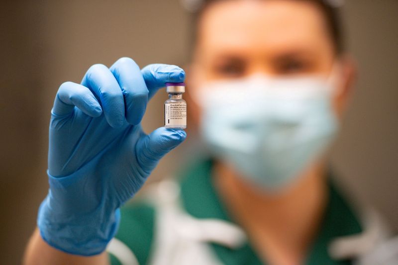 FILE PHOTO: A nurse holds a phial of the Pfizer/BioNTech