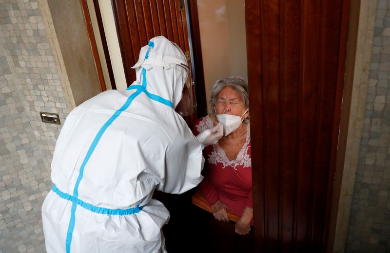 FILE PHOTO: Medics visit homes of suspected coronavirus disease (COVID-19)