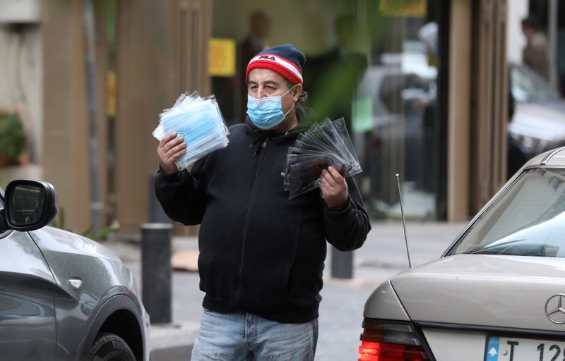 A street vendor sells face masks used to prevent the