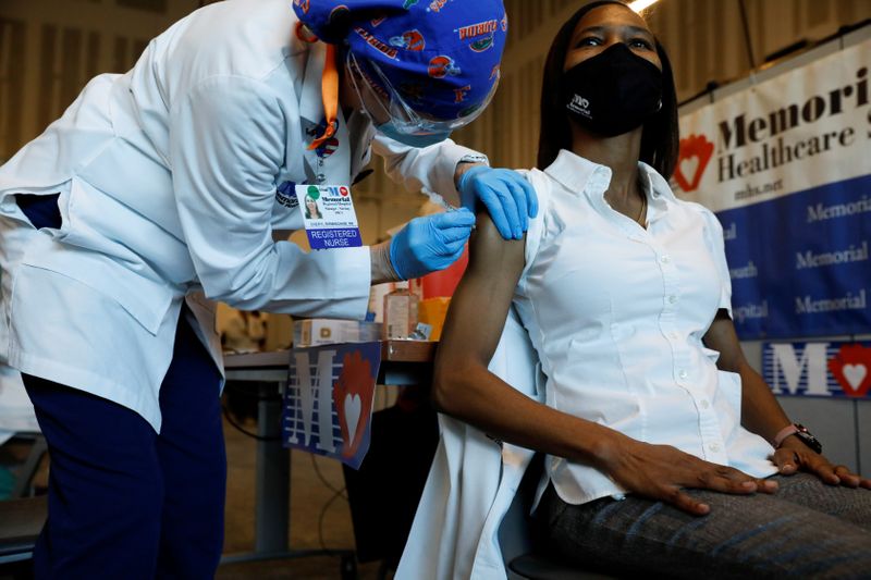 FILE PHOTO: Health Care workers receive the Pfizer-BioNTech COVID-19 Vaccine