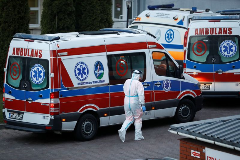 A paramedic walks near an ambulance amid the coronavirus disease