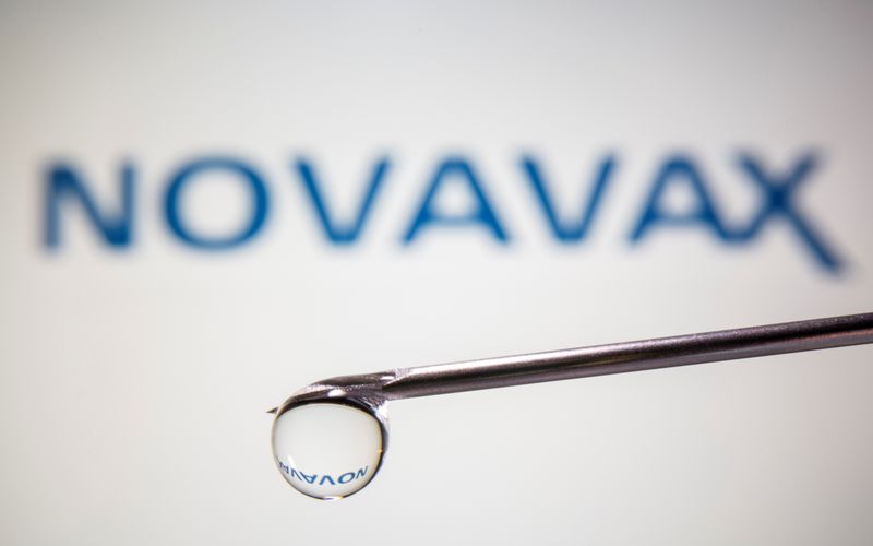 A Novavax logo is reflected in a drop on a