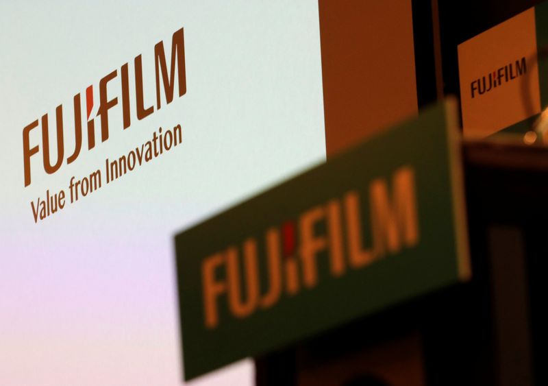 Fujifilm Holdings’ logos are pictured ahead of its news conference