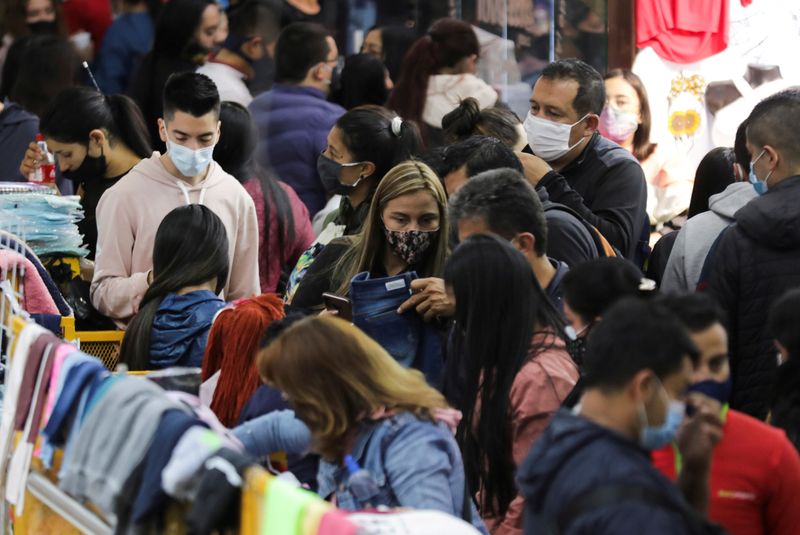 FILE PHOTO: People wearing face masks shop in the commercial