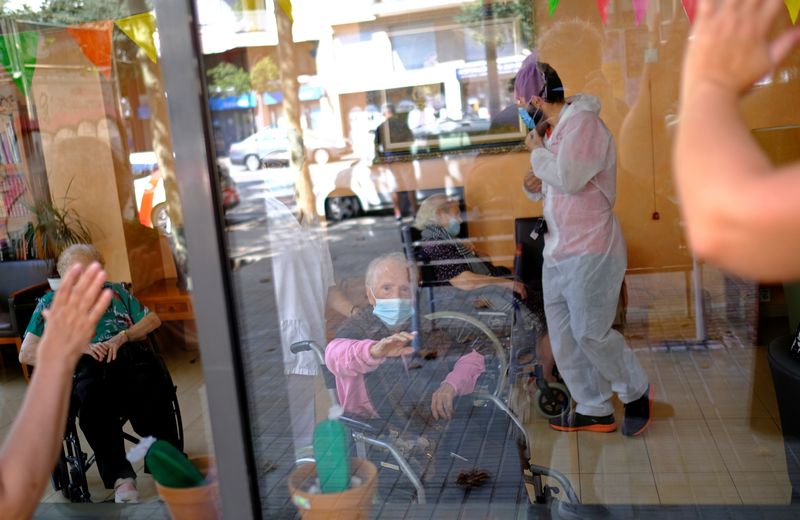 FILE PHOTO: Elderly people get love through nursing home glass