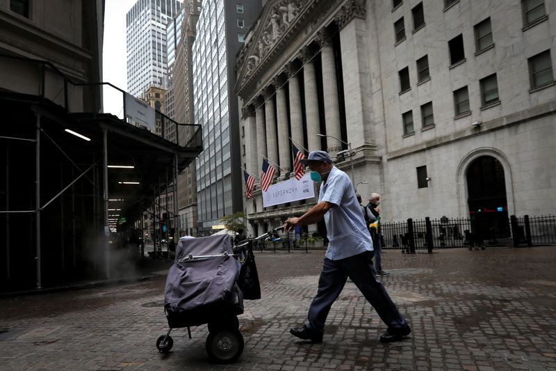 A USPS mail carrier walks past New York Stock Exchange