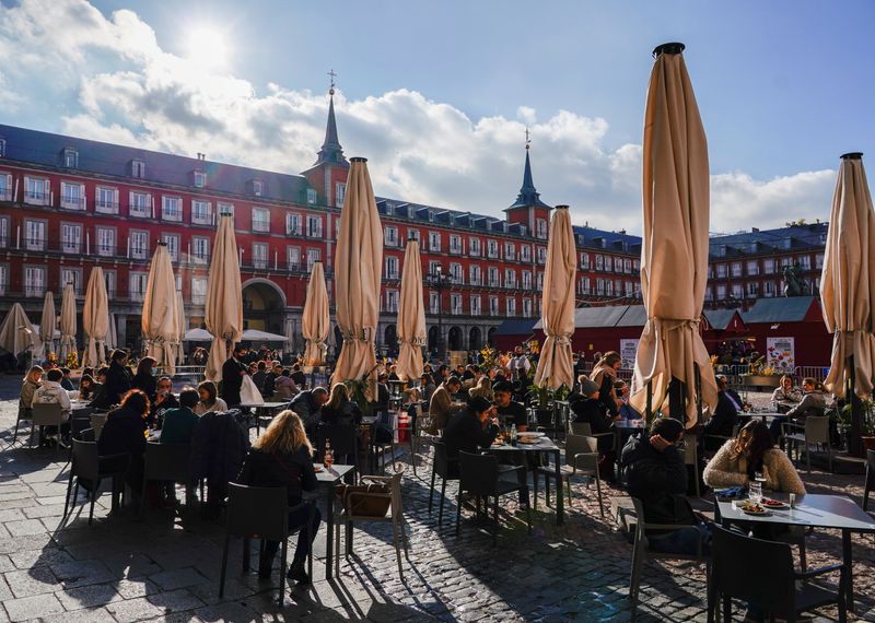 People sit on a terrace in Madrid