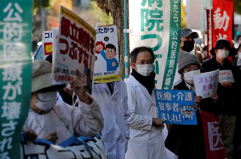 Protesters wearing masks, amid the coronavirus disease (COVID-19) outbreak, hold