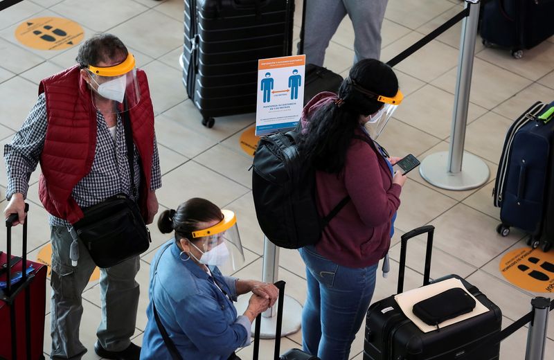Passengers stand in line at the Tocumen International Airport during