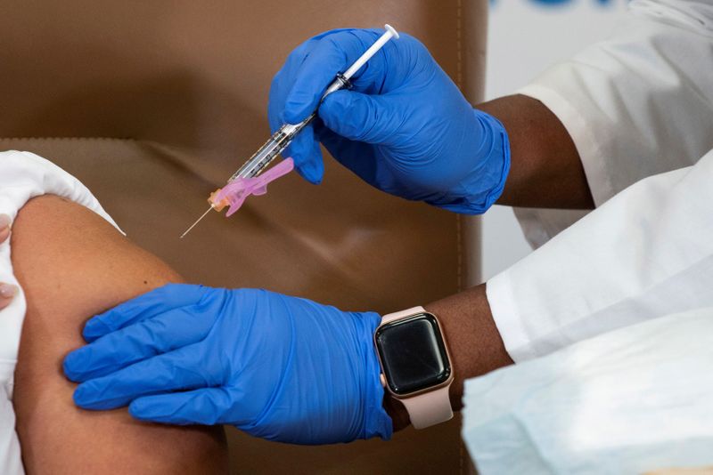 FILE PHOTO: Healthcare workers receive the Moderna COVID-19 vaccine in