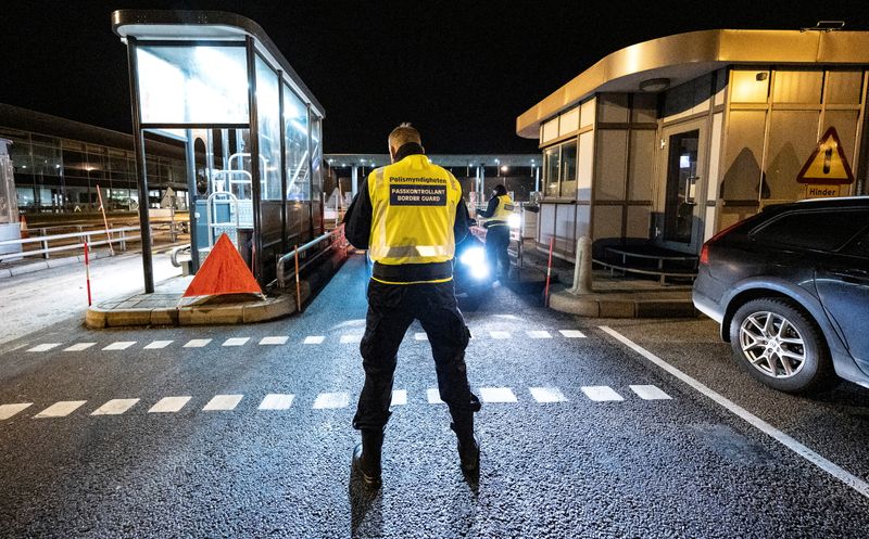A border control officer stands at Oresund bridge connecting Sweden